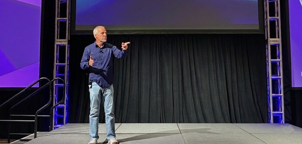 Jim Harrer speaking at a tech conference